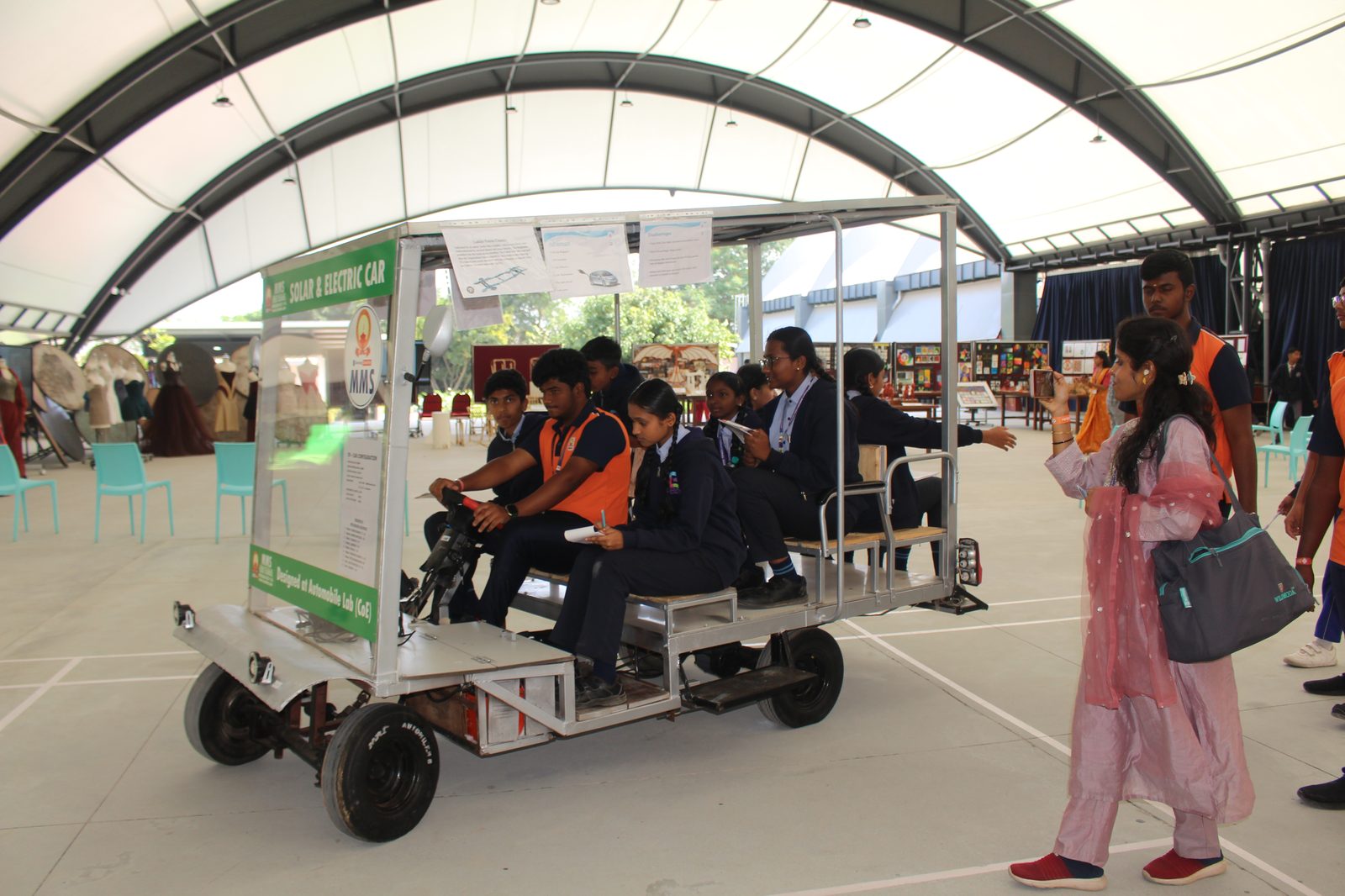 A visitor photographing the Solar and Electric Car in action at Alliance NOVA Fest
