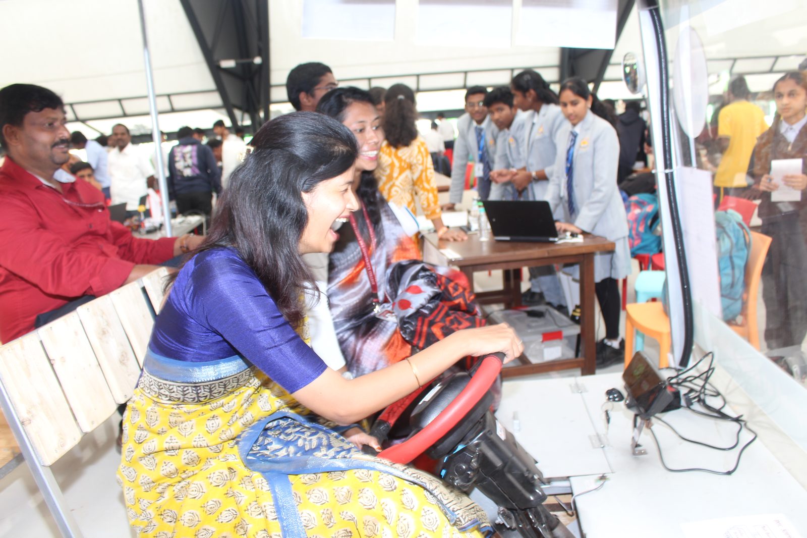 Visitors gathered around the Solar and Electric Car at the MMS stall