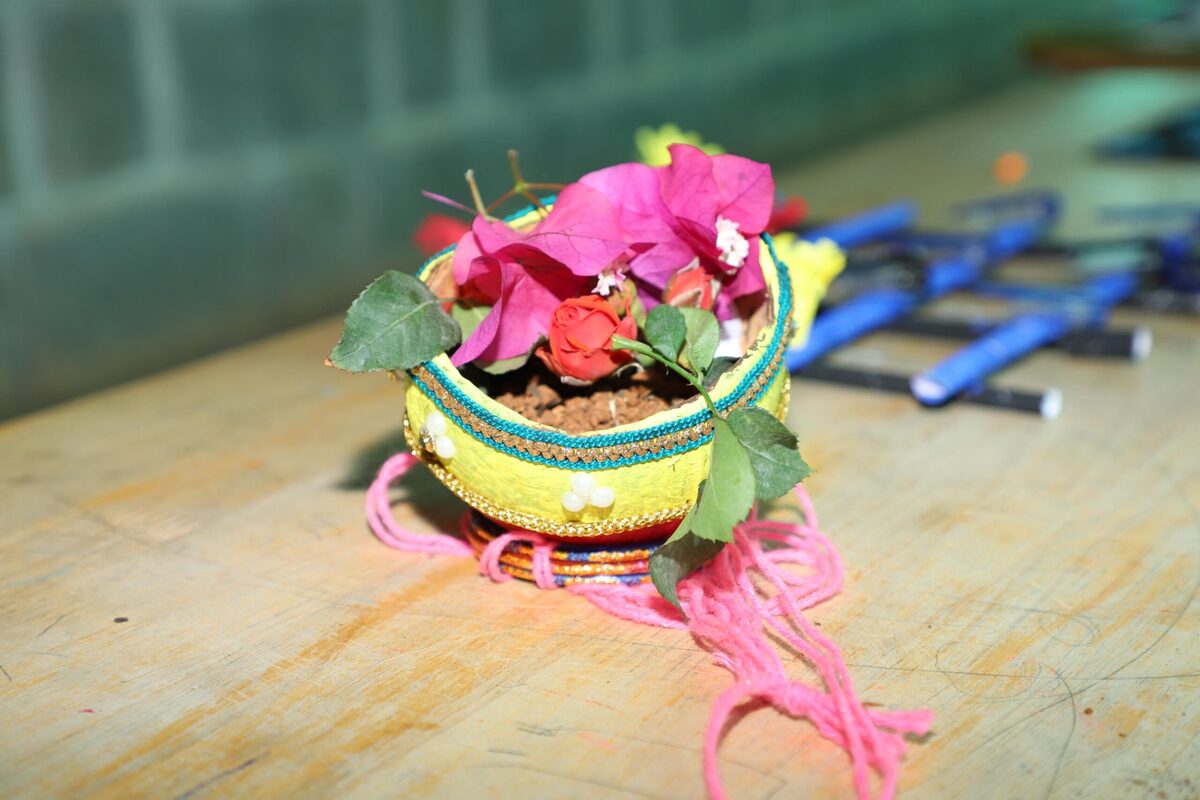 A handmade decorative pot arrangement with fresh flowers