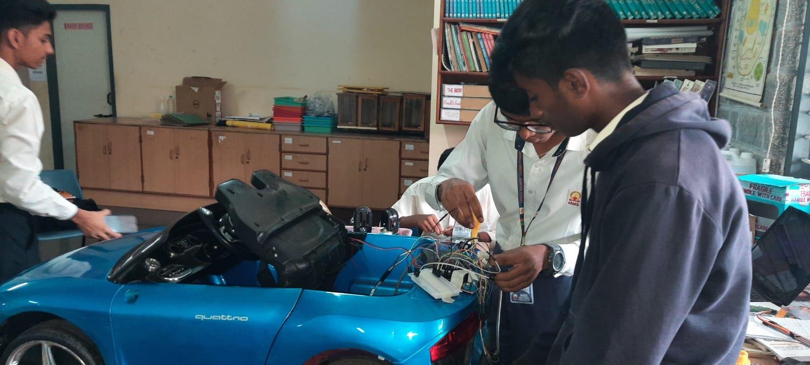 Students building autopilot car electronics