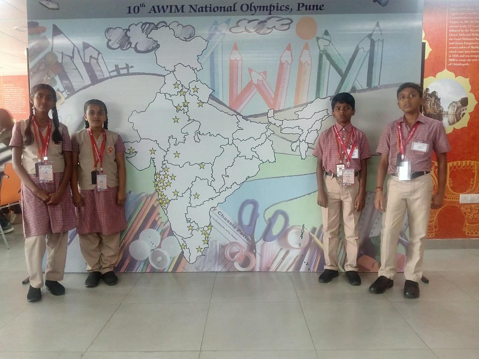 MMS students standing in front of the 10th AWIM National Olympics backdrop at the venue in Pune, 2018