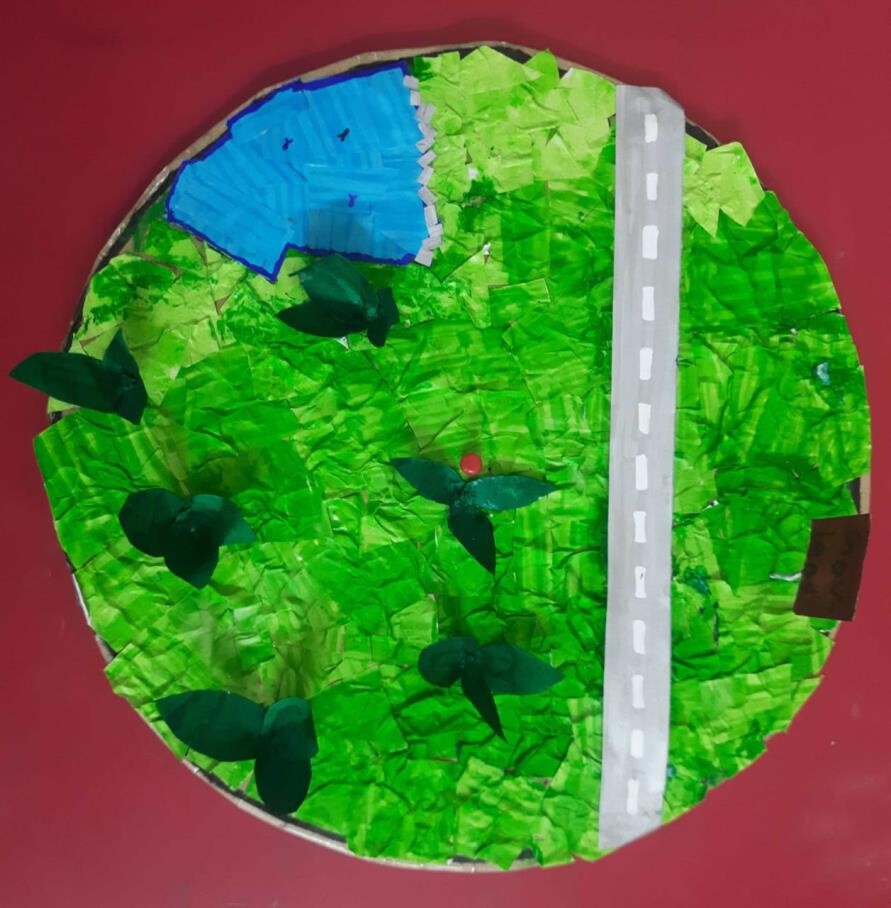 A paper craft model of a circular garden with a path running through it, illustrating the problem statement