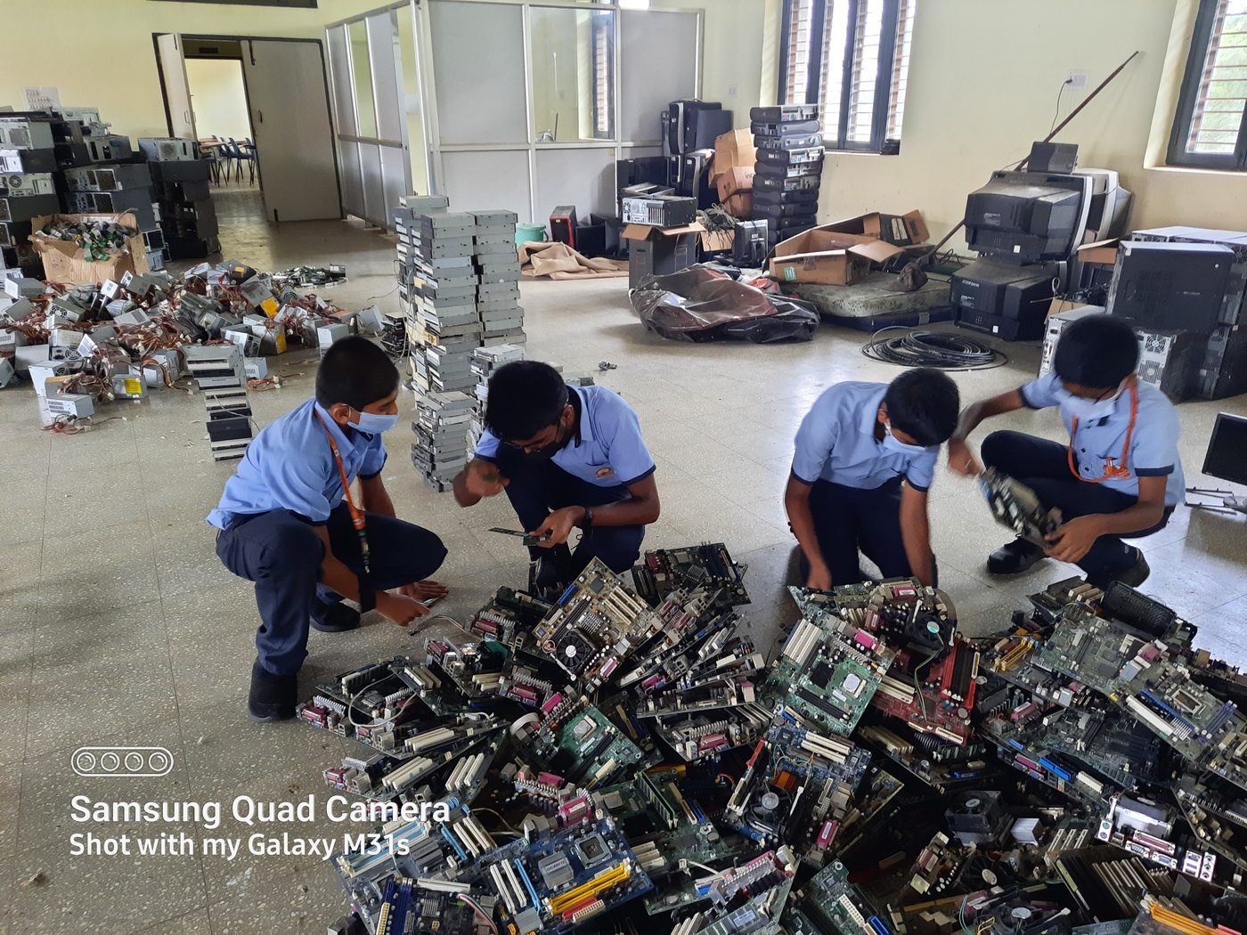 Students sorting salvaged motherboards from retired desktops