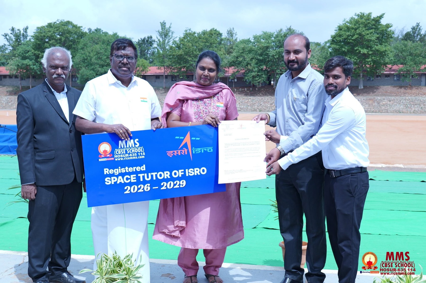 MMS management and staff holding the Registered Space Tutor of ISRO banner and confirmation letter