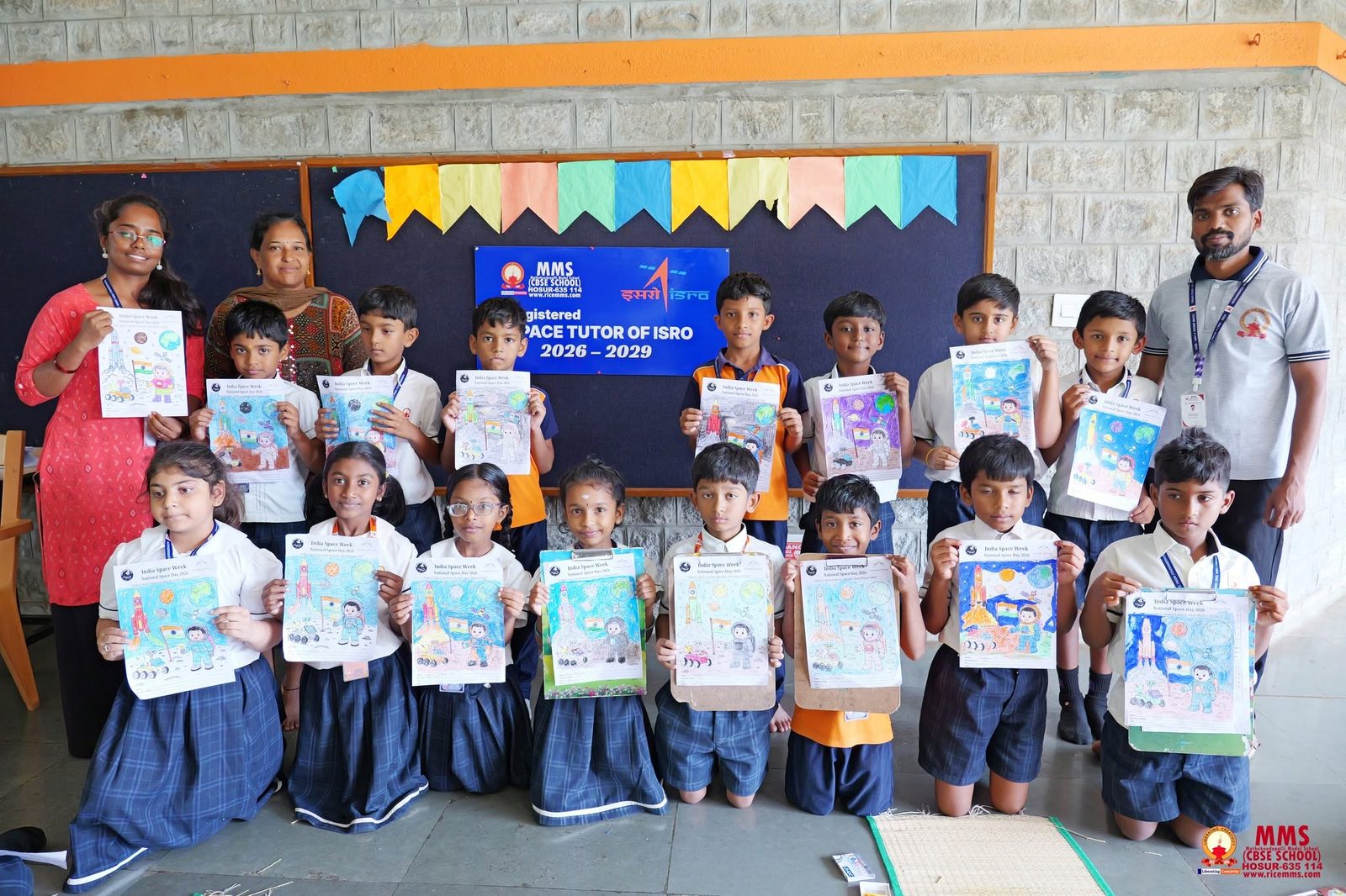 Students showing their India Space Week colouring artwork