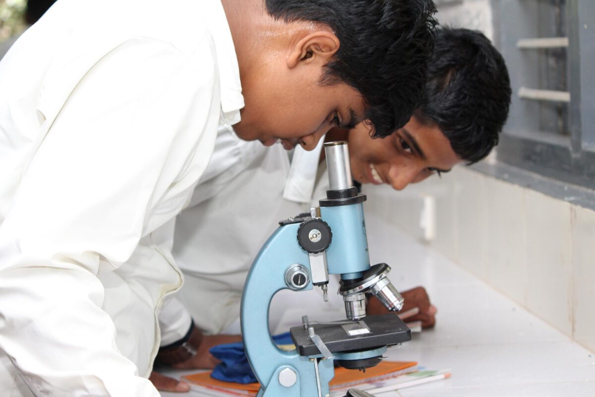 Students observing cell structures under the microscope