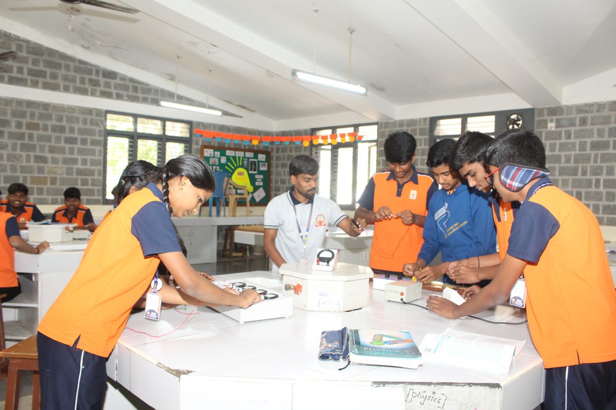 Students working together in a group at the physics workbench