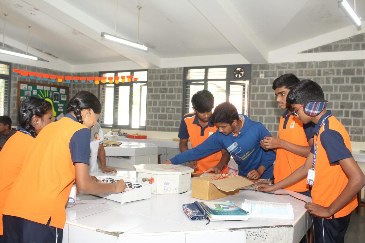 Students preparing circuit apparatus for a physics practical