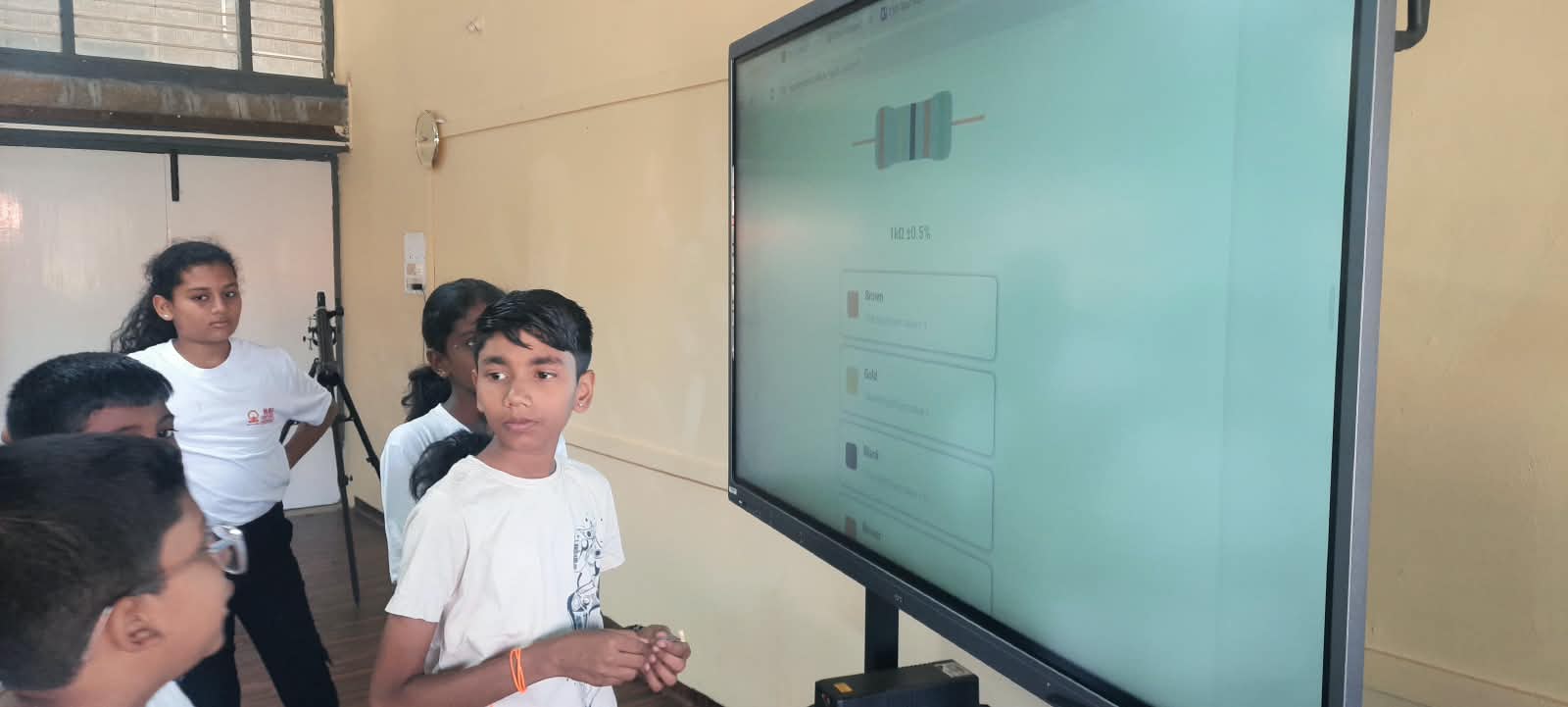 Students calculating resistance using the colour code on a smart display
